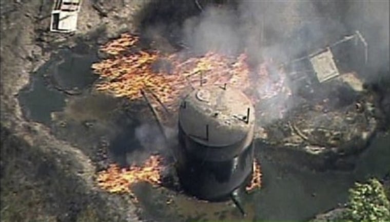 A fire rustling from a natural gas well explosion burns in Indianola, Pa., on Friday.